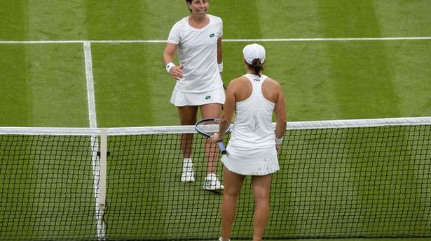 Barty through as rain hits Wimbledon again