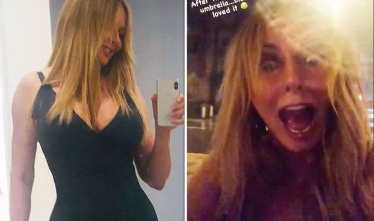 Carol Vorderman screams as she gets drenched in rain wearing very busty dress on night out