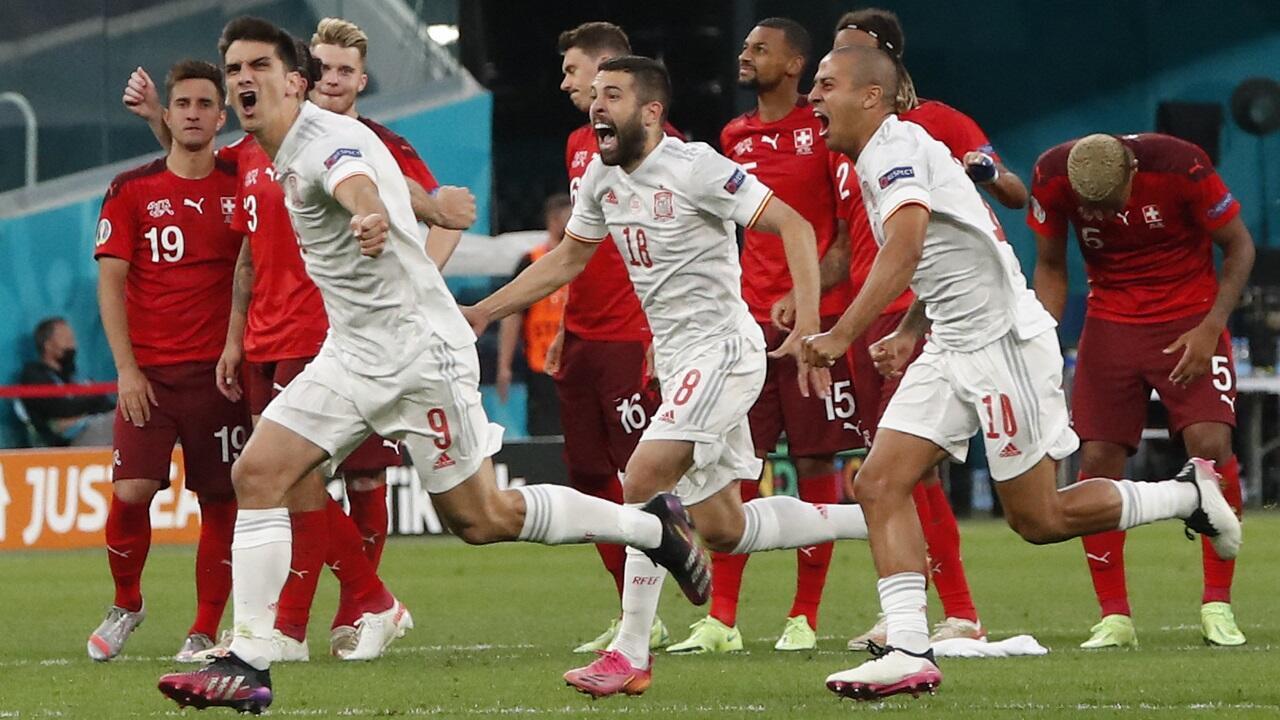 Spain beat 10-man Switzerland on penalties to reach the semi-finals