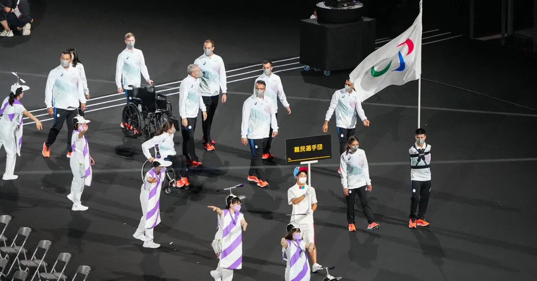 Refugees lead the parade of athletes.